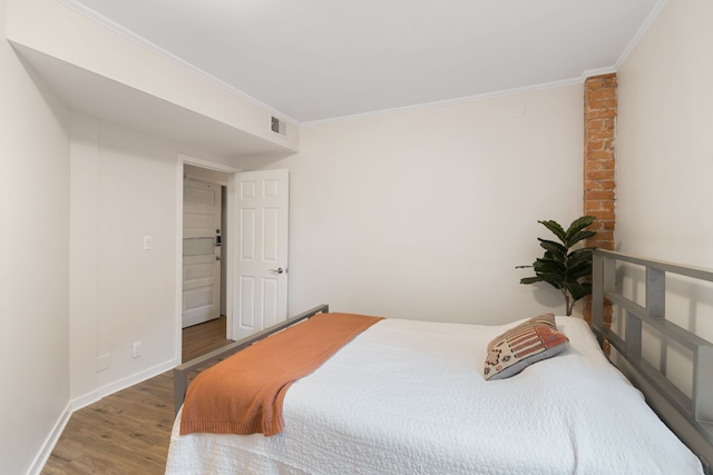 bedroom featuring wood-type flooring and ornamental molding