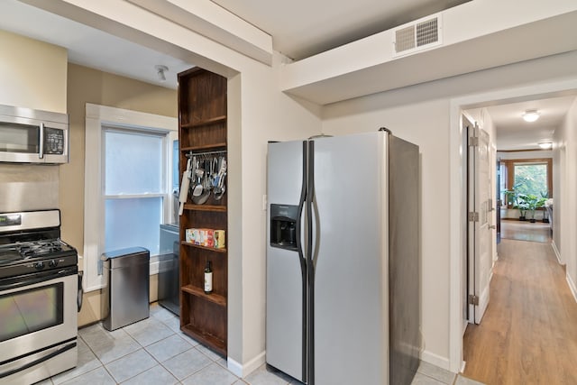 kitchen featuring appliances with stainless steel finishes and light hardwood / wood-style floors