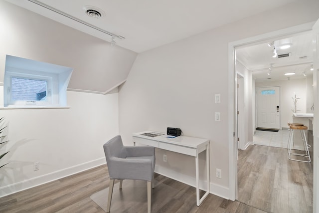 office area featuring hardwood / wood-style floors and rail lighting