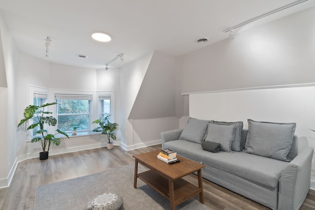 living room featuring hardwood / wood-style floors and track lighting