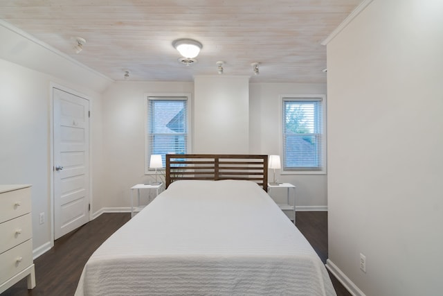 bedroom featuring ornamental molding, dark hardwood / wood-style floors, and wooden ceiling