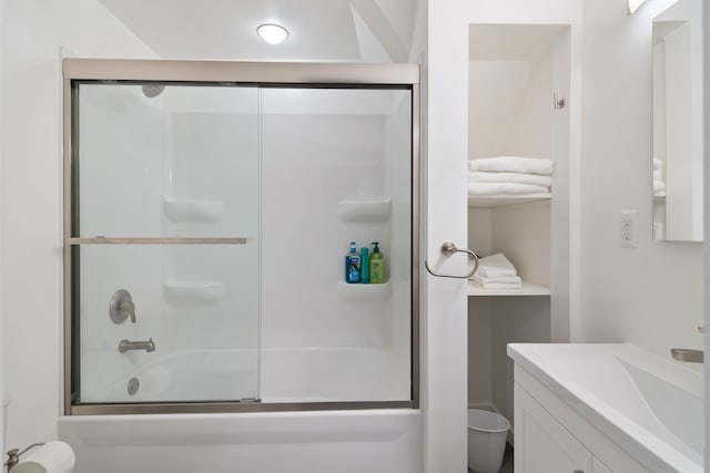 bathroom with vanity and enclosed tub / shower combo