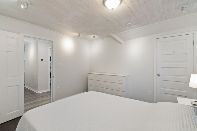 bedroom featuring dark hardwood / wood-style flooring and wooden ceiling