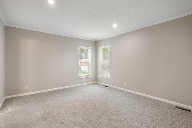 carpeted spare room featuring a textured ceiling and ornamental molding