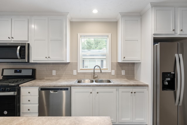 kitchen with sink, white cabinetry, and stainless steel appliances