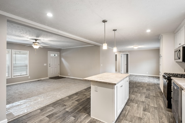 kitchen featuring pendant lighting, a center island, white cabinets, hardwood / wood-style flooring, and appliances with stainless steel finishes