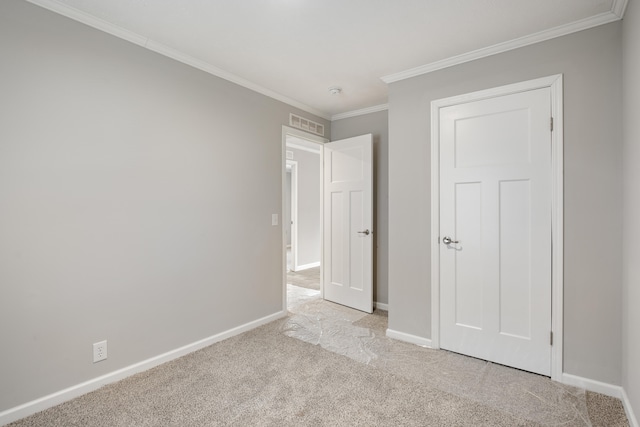 unfurnished bedroom featuring light colored carpet and crown molding