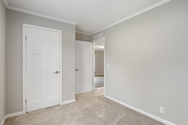 unfurnished bedroom with light colored carpet and ornamental molding