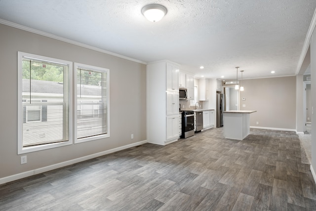 unfurnished living room featuring hardwood / wood-style flooring, crown molding, and a textured ceiling