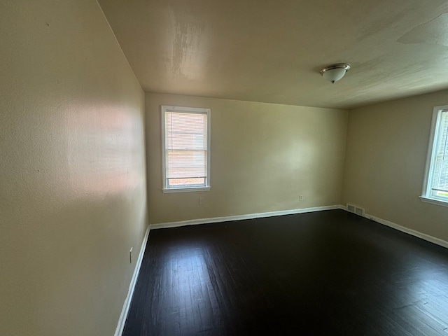 spare room featuring dark hardwood / wood-style floors