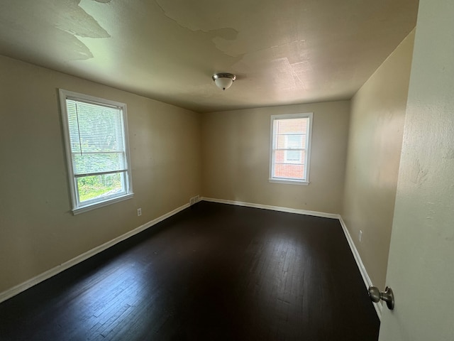 empty room featuring dark wood-type flooring