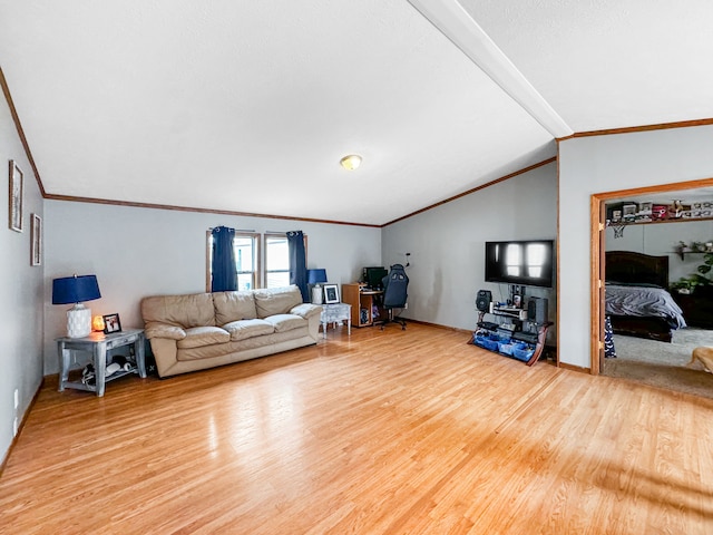 living room featuring lofted ceiling, wood-type flooring, and ornamental molding