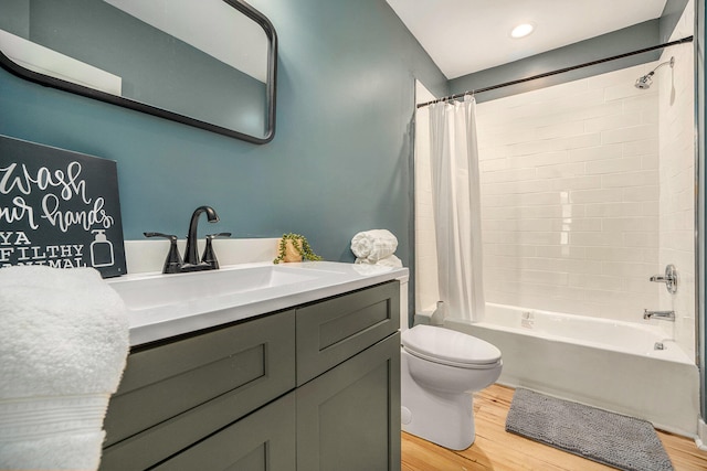 full bathroom featuring hardwood / wood-style floors, vanity, toilet, and shower / bathtub combination with curtain