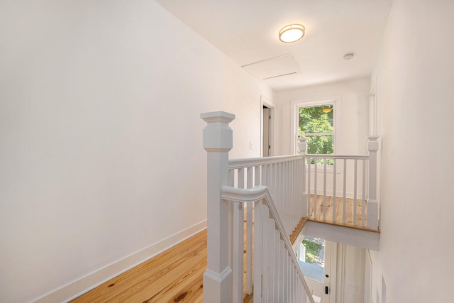 corridor with light hardwood / wood-style floors