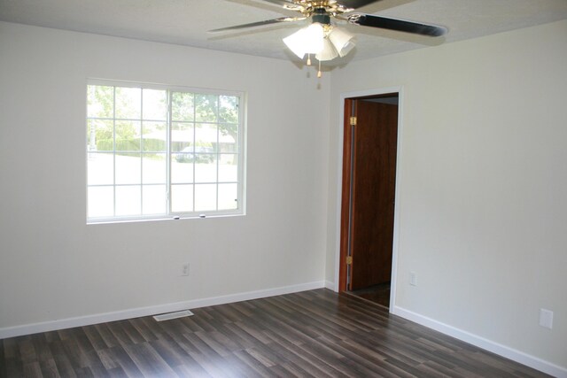 2960 W John Beers Rd, Stevensville, MI 49127 - spare room with dark wood-style flooring, a ceiling fan, and baseboards