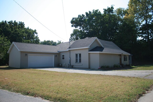2960 W John Beers Rd, Stevensville, MI 49127 - ranch-style home with a front lawn, an attached garage, driveway, and roof with shingles