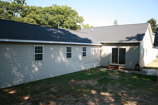 2960 W John Beers Rd, Stevensville, MI 49127 - rear view of house with entry steps, a lawn, and roof with shingles