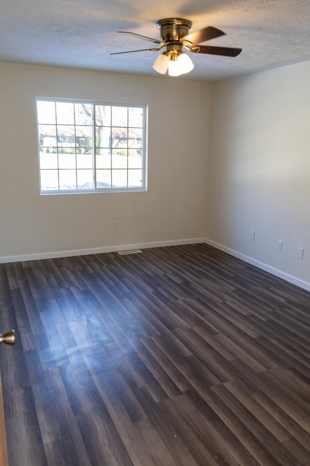 2960 W John Beers Rd, Stevensville, MI 49127 - unfurnished room with plenty of natural light, ceiling fan, dark wood finished floors, a textured ceiling, and baseboards
