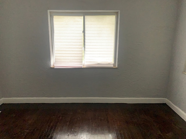 empty room featuring dark wood-type flooring