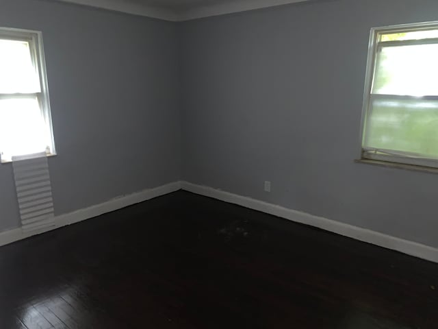 empty room with dark hardwood / wood-style floors