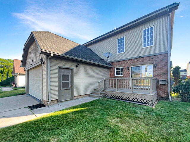 back of house featuring a lawn, a wooden deck, and a garage