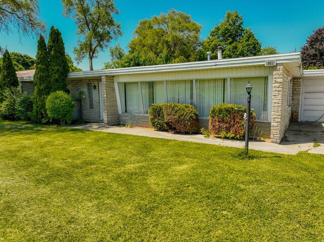 1208 S Lapeer Rd, Lapeer, MI 48446 - view of front facade with a front yard and stone siding