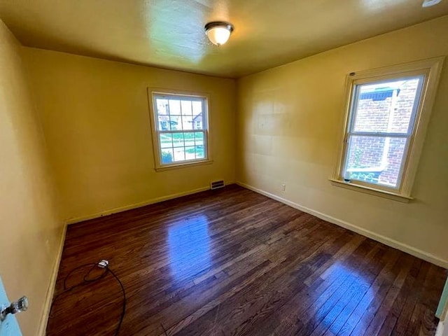 empty room featuring dark wood-type flooring