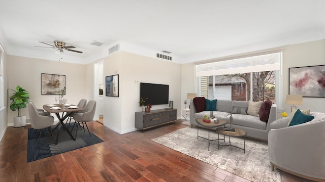 living room with dark hardwood / wood-style flooring and ceiling fan