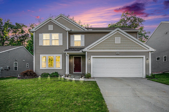 view of front of property with a yard and a garage