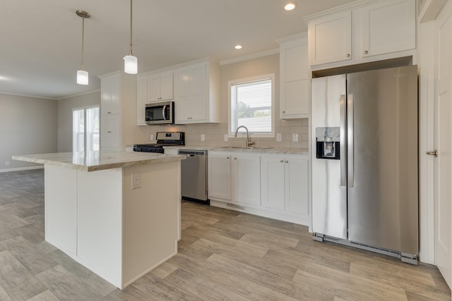 kitchen featuring white cabinetry, a center island, stainless steel appliances, and sink