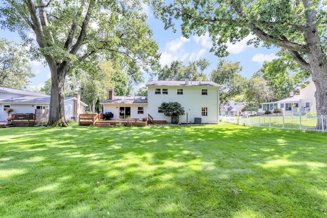 back of house featuring a yard and a deck