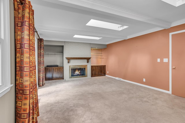 unfurnished living room featuring carpet flooring, crown molding, and a fireplace
