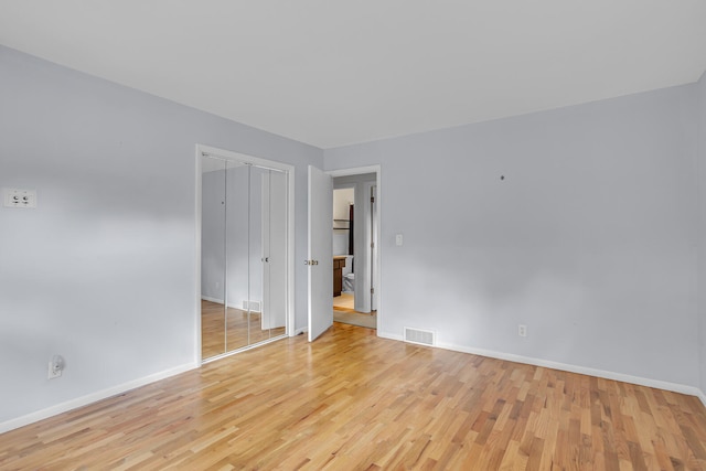 spare room featuring light hardwood / wood-style floors