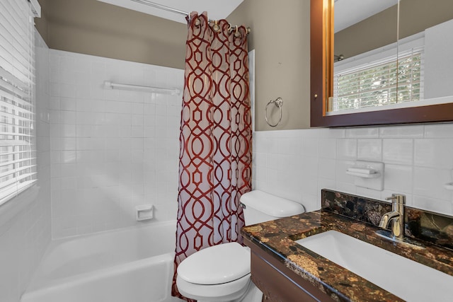 full bathroom with tile walls, toilet, decorative backsplash, vanity, and shower / tub combo