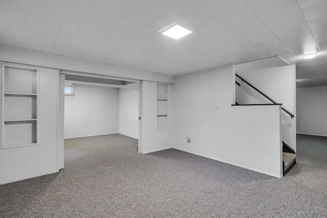 basement with dark carpet and built in features