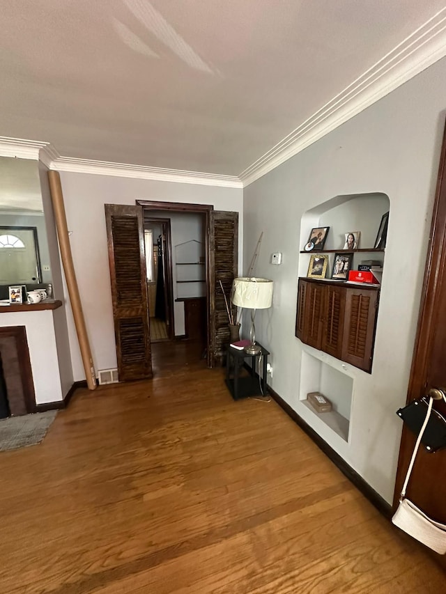 hall featuring hardwood / wood-style floors and crown molding