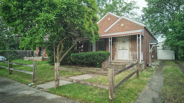 view of front of house with a garage and an outbuilding