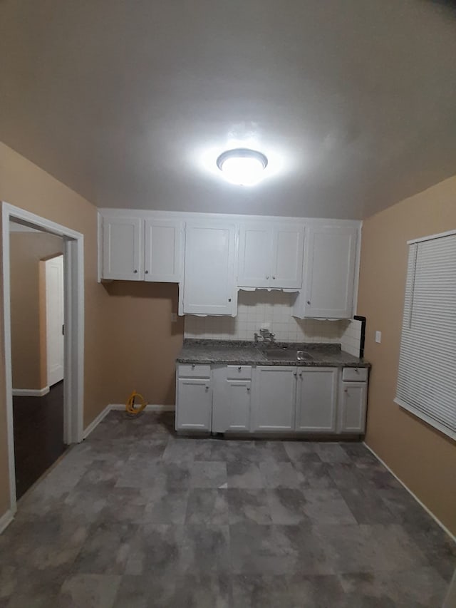 kitchen featuring white cabinets and tasteful backsplash