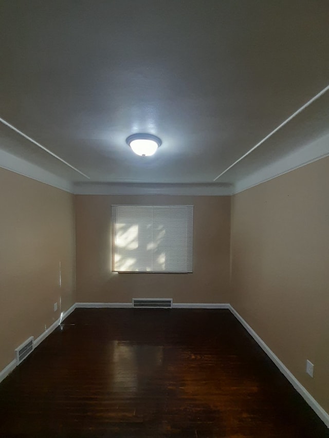 spare room with dark hardwood / wood-style flooring