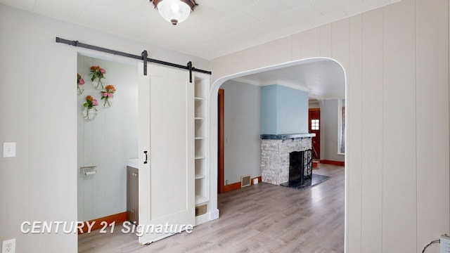 interior space featuring a barn door and light wood-type flooring