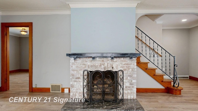 room details featuring crown molding, wood-type flooring, and a fireplace