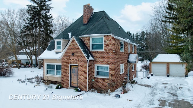 view of front of property with a garage and an outdoor structure