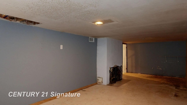 basement featuring a textured ceiling