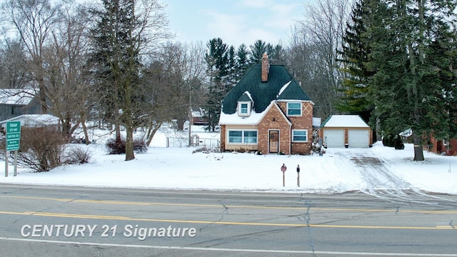 view of front of property featuring a garage and an outdoor structure