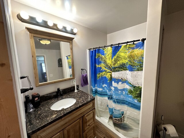 2717 N Sherman Rd, Ludington, MI 49431 - bathroom featuring vanity and a shower with shower curtain