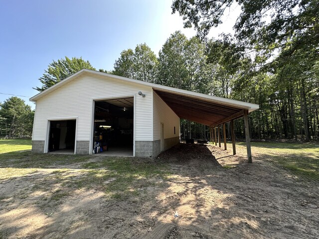 2717 N Sherman Rd, Ludington, MI 49431 - view of property exterior featuring a detached garage and an outbuilding