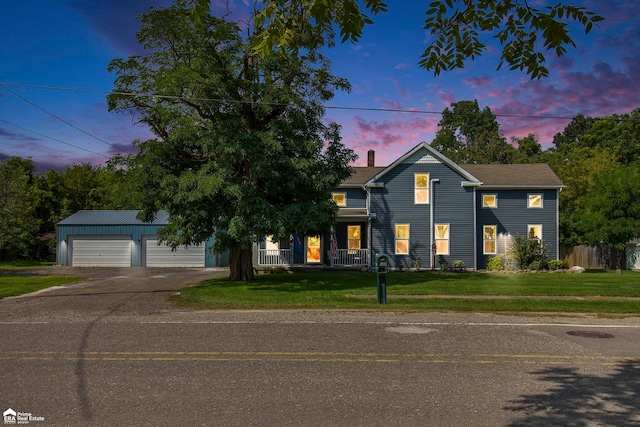 view of front of home featuring a lawn, an outbuilding, and a garage