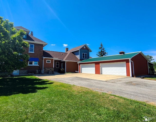 view of front of home with a front yard and a garage