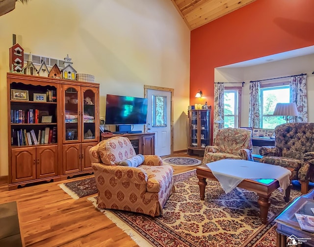 living room with wood-type flooring, high vaulted ceiling, and wood ceiling