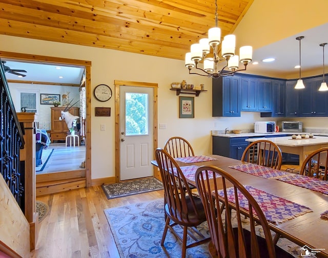 dining space featuring vaulted ceiling, wooden ceiling, ceiling fan with notable chandelier, and light wood-type flooring